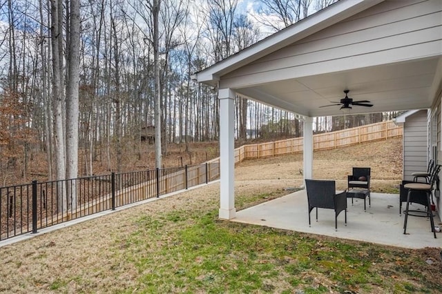 view of yard with ceiling fan and a patio