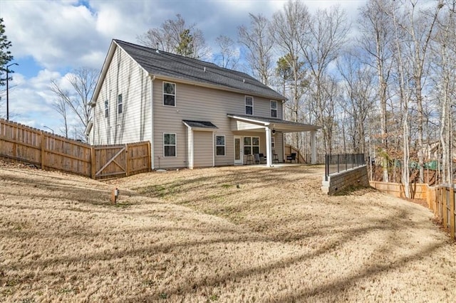 back of house featuring a lawn