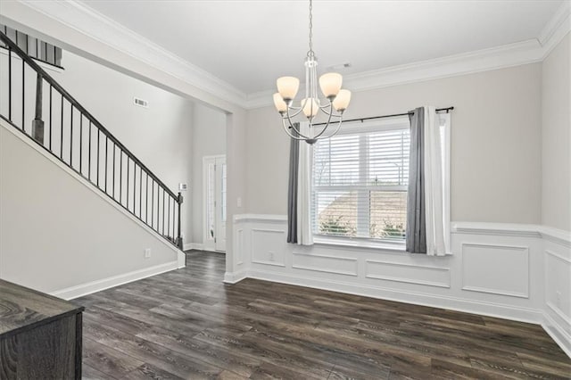 unfurnished dining area featuring ornamental molding, a notable chandelier, and dark hardwood / wood-style flooring