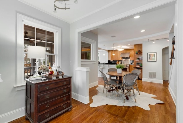 dining room with visible vents, baseboards, and wood finished floors