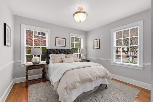 bedroom featuring wood finished floors and baseboards