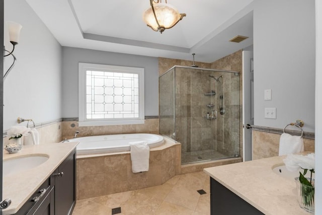 full bath featuring visible vents, a shower stall, a tray ceiling, a bath, and vanity