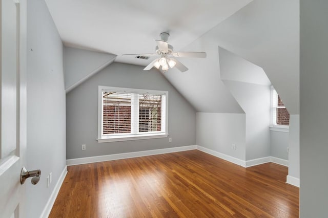 bonus room featuring ceiling fan, lofted ceiling, baseboards, and wood finished floors