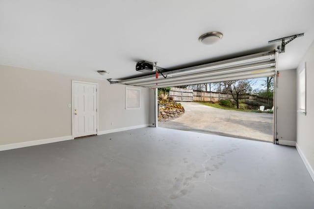 garage with a garage door opener and baseboards