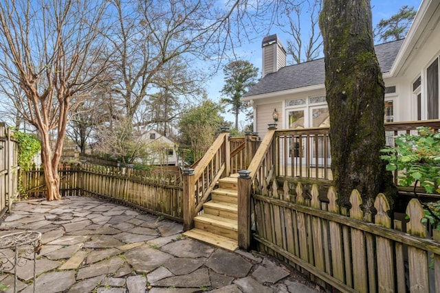 wooden deck featuring a patio area and fence private yard