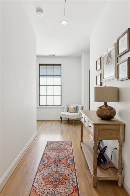 hallway with baseboards, recessed lighting, and wood finished floors