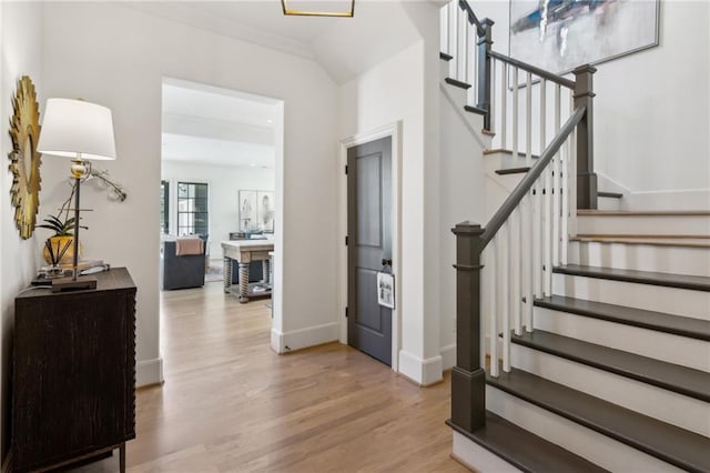 staircase with baseboards and wood finished floors