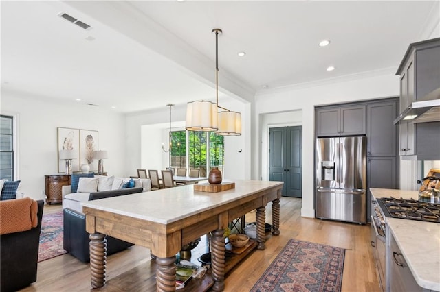 kitchen featuring hanging light fixtures, light wood-style flooring, stainless steel appliances, recessed lighting, and visible vents
