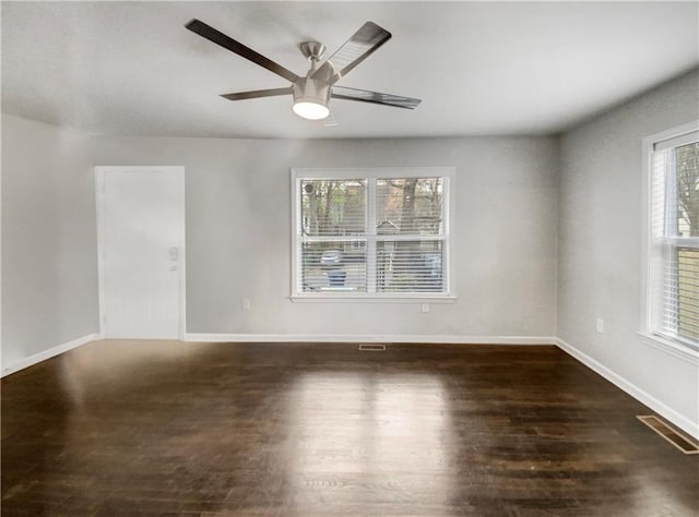 spare room with ceiling fan and dark hardwood / wood-style floors