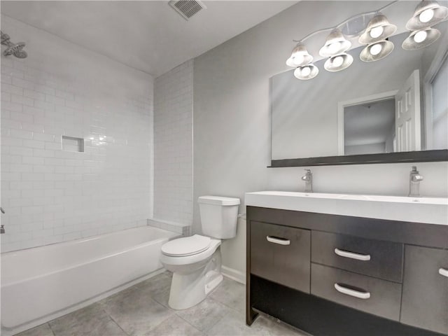 full bathroom with vanity, tile patterned flooring, tiled shower / bath, and toilet