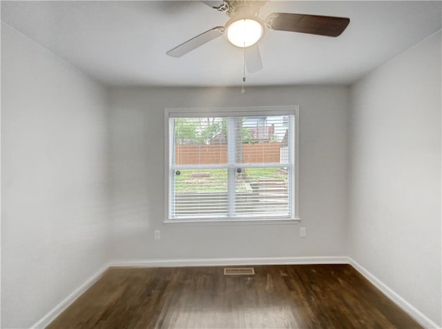 spare room with ceiling fan and dark hardwood / wood-style floors