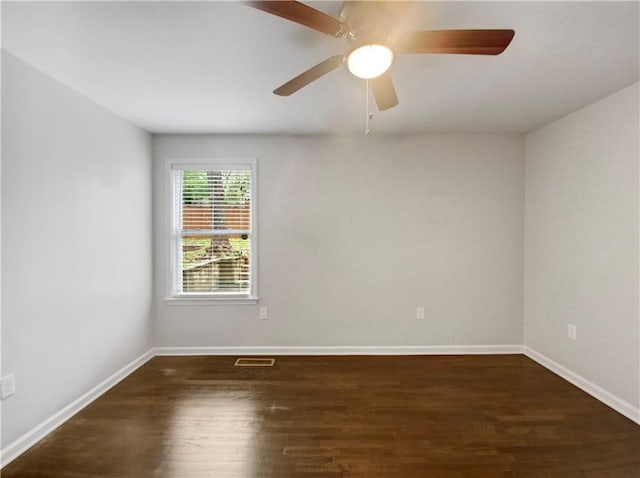 spare room featuring ceiling fan and dark wood-type flooring