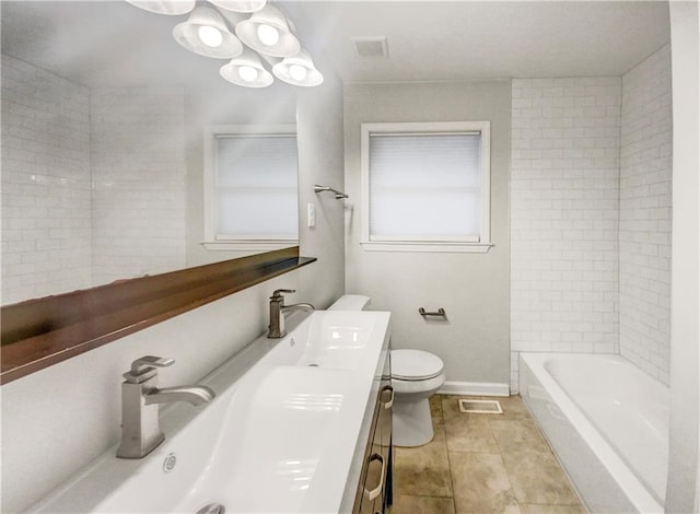 full bathroom featuring tile patterned flooring, vanity, toilet, and tiled shower / bath