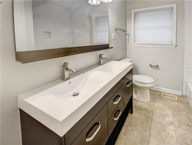 bathroom featuring tile patterned flooring, vanity, and toilet