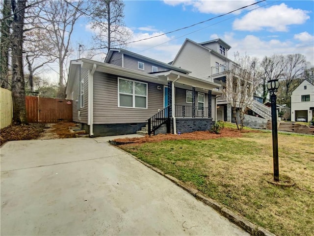 view of front property featuring a balcony and a front lawn