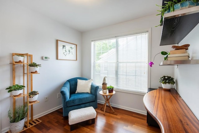 sitting room with baseboards, wood finished floors, and visible vents