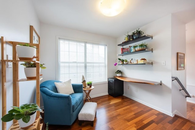 sitting room with baseboards and wood finished floors