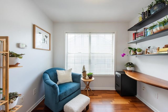 sitting room featuring baseboards and light wood-style flooring