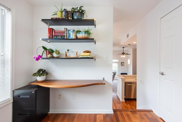 bar with visible vents, wood finished floors, baseboards, a ceiling fan, and dishwasher