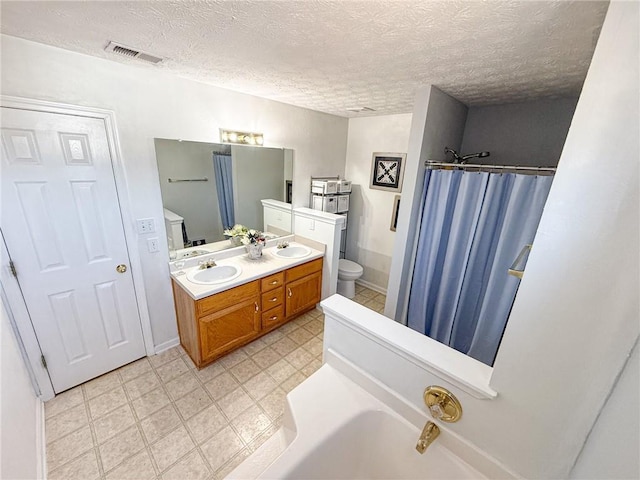 bathroom featuring toilet, a shower with shower curtain, a sink, and visible vents