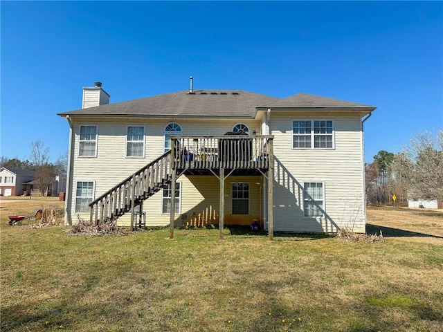 back of house featuring a chimney, a lawn, stairway, and a wooden deck