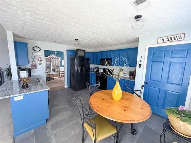 dining area with a textured ceiling and visible vents