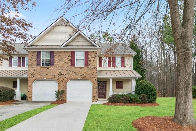 184 Darbys Crossing Ct, Hiram, GA 30141 - view of front of property with a standing seam roof, driveway, brick siding, a front lawn, and an attached garage