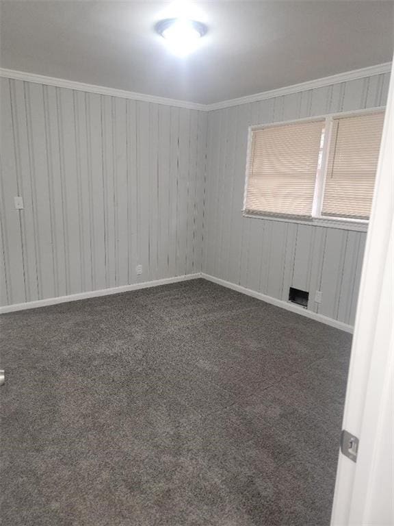 carpeted empty room featuring ornamental molding