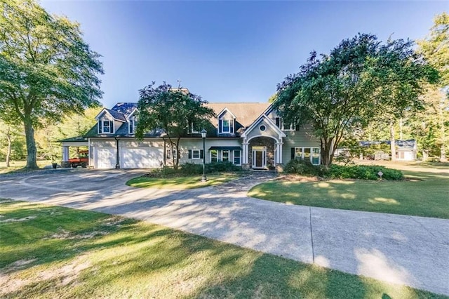 view of front of house with a garage and a front lawn