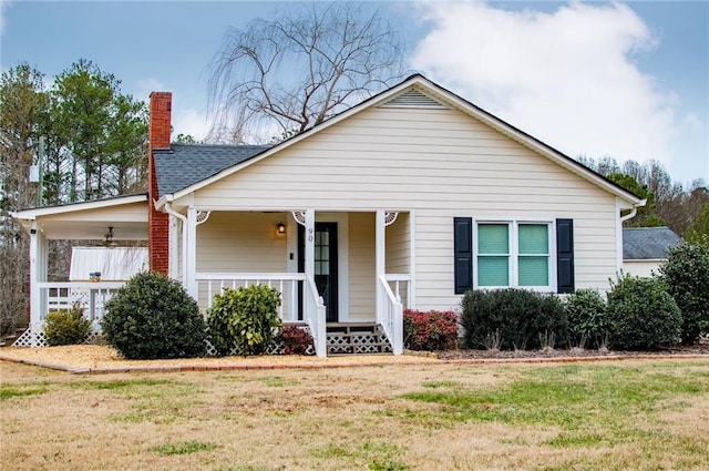 view of front of home with a porch and a front lawn