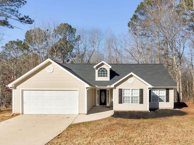 view of front of property featuring a garage, driveway, roof with shingles, and a front yard