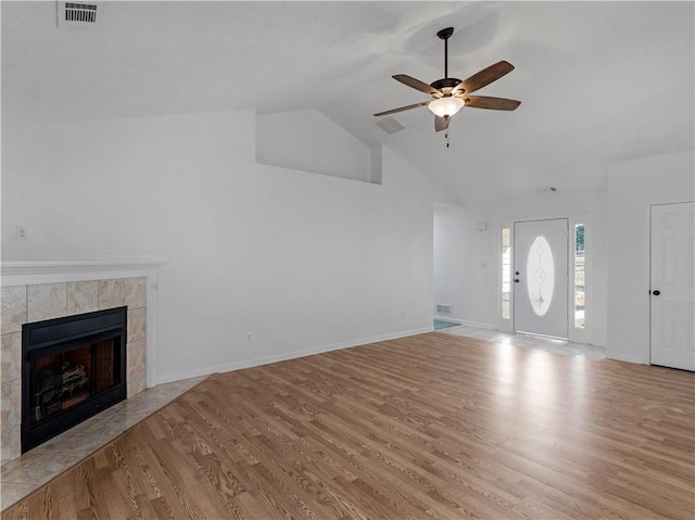 unfurnished living room with light wood-type flooring, visible vents, and a fireplace