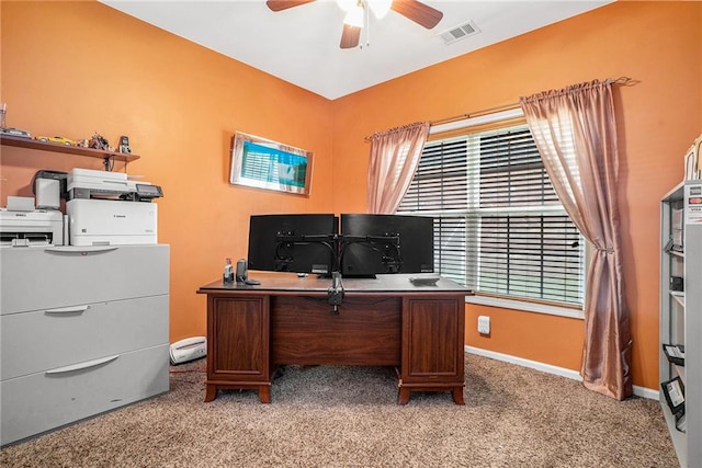 office space featuring ceiling fan, a healthy amount of sunlight, and light carpet