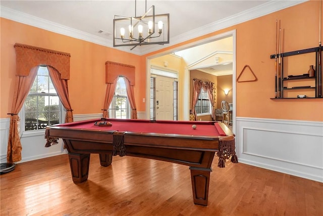 game room with hardwood / wood-style flooring and crown molding