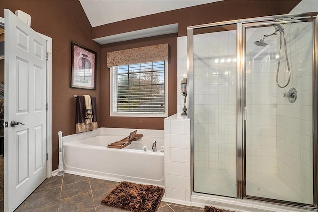 bathroom with plus walk in shower, vaulted ceiling, and tile patterned floors