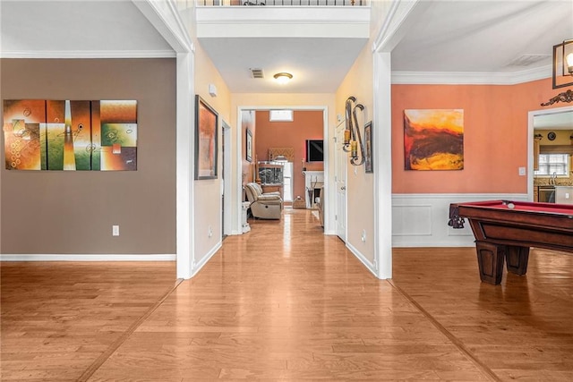 entrance foyer featuring light hardwood / wood-style floors, billiards, and crown molding