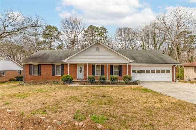 single story home featuring driveway, brick siding, a front lawn, and an attached garage