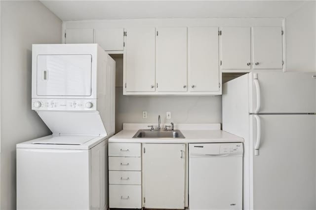 laundry room featuring stacked washer / dryer, laundry area, and a sink