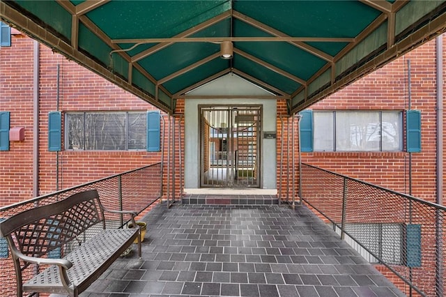 entrance to property featuring brick siding