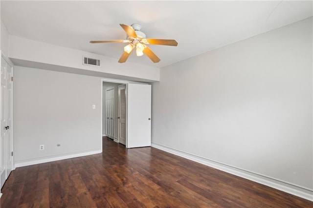 unfurnished room with baseboards, visible vents, ceiling fan, and wood finished floors