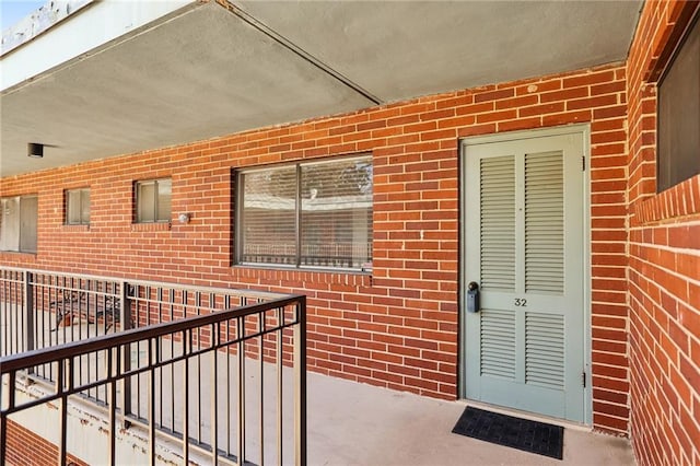 doorway to property with brick siding