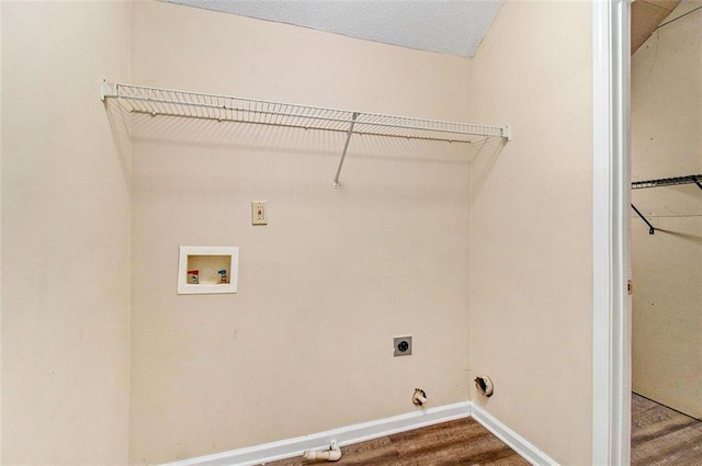 laundry area with laundry area, baseboards, dark wood-type flooring, washer hookup, and electric dryer hookup