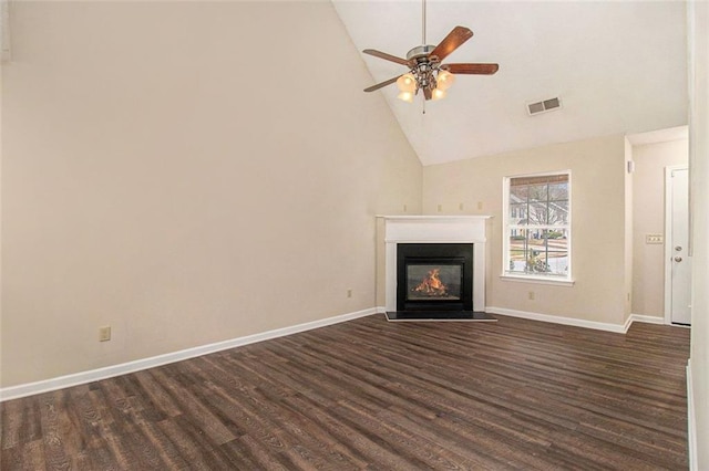 unfurnished living room with dark wood finished floors, visible vents, a fireplace with flush hearth, a ceiling fan, and baseboards