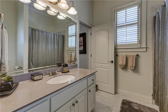 bathroom with vanity, baseboards, and tile patterned flooring