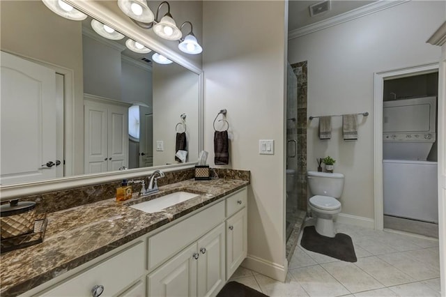 full bathroom featuring visible vents, stacked washer and clothes dryer, a shower stall, crown molding, and vanity