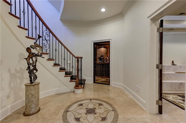 entryway with visible vents, baseboards, recessed lighting, stairs, and crown molding