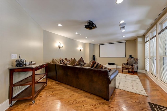 cinema with visible vents, baseboards, wood finished floors, and recessed lighting