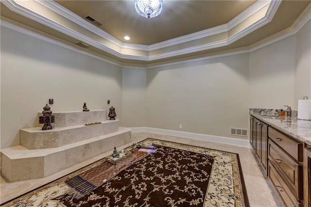 bar with a tray ceiling, visible vents, and ornamental molding