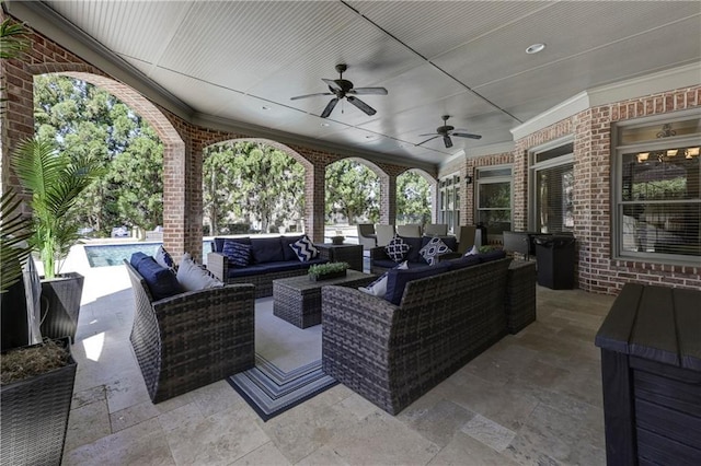 view of patio / terrace with outdoor lounge area, an outdoor pool, and ceiling fan