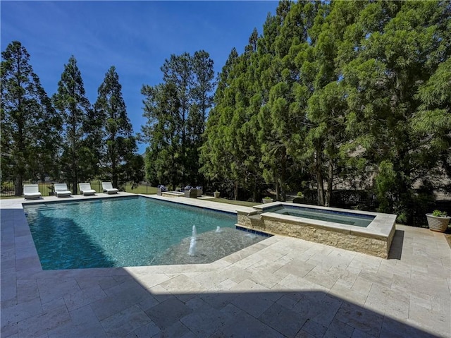 view of pool featuring a patio and a pool with connected hot tub